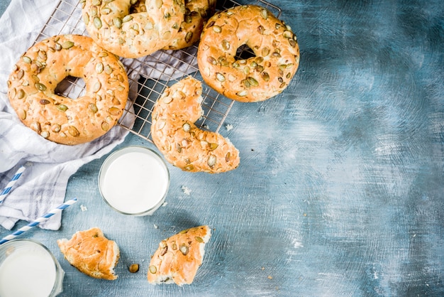 Healthy breakfast concept, home made cereal bagels with milk glass