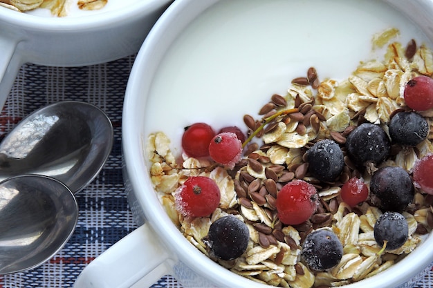 Healthy breakfast or dessert with dairy yogurt, seeds and berries.