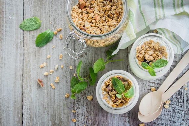 Healthy breakfast. Homemade oat granola with greek yogurt and mint leaves