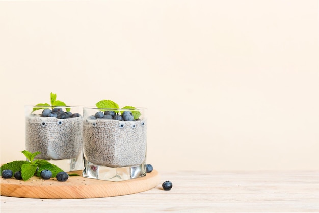 Healthy breakfast or morning with chia seeds vanilla pudding and blueberry berries on table background vegetarian food diet and health concept Chia pudding with coconut milk and blueberry