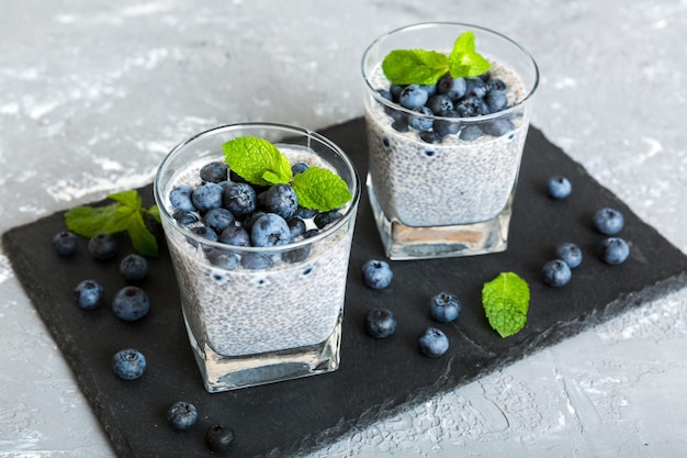 Healthy breakfast or morning with chia seeds vanilla pudding and blueberry berries on table background vegetarian food diet and health concept Chia pudding with coconut milk and blueberry