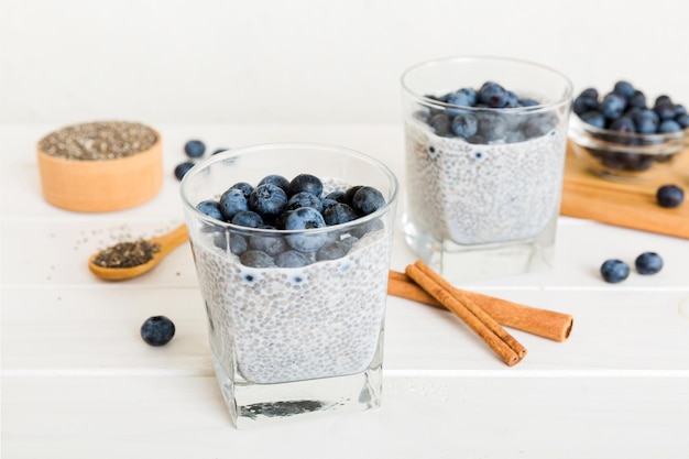 Healthy breakfast or morning with chia seeds vanilla pudding and blueberry berries on table background vegetarian food diet and health concept Chia pudding with coconut milk and blueberry