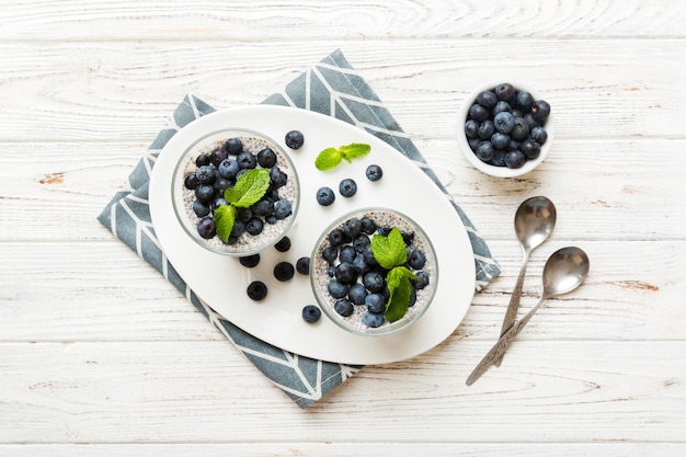 Healthy breakfast or morning with chia seeds vanilla pudding and blueberry berries on table background vegetarian food diet and health concept Chia pudding with coconut milk and blueberry