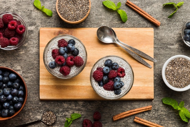 Healthy breakfast or morning with chia seeds vanilla pudding raspberry and blueberry berries on table background vegetarian food diet and health concept Chia pudding with raspberry and blueberry