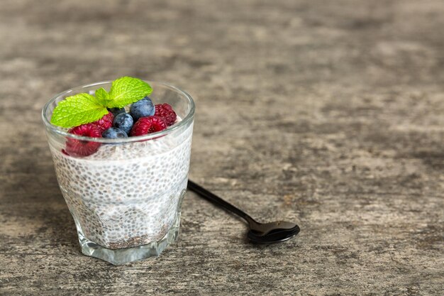 Healthy breakfast or morning with chia seeds vanilla pudding raspberry and blueberry berries on table background vegetarian food diet and health concept Chia pudding with raspberry and blueberry