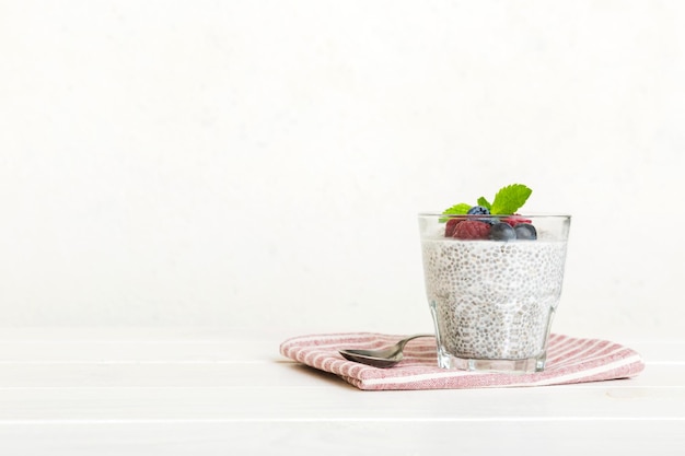 Healthy breakfast or morning with chia seeds vanilla pudding raspberry and blueberry berries on table background vegetarian food diet and health concept Chia pudding with raspberry and blueberry