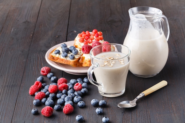 Healthy breakfast overnight oats with fresh berries in a glass jar