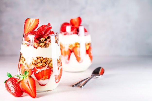 Healthy breakfast of strawberry parfaits made with fresh strawberry yogurt and muesli in glasses