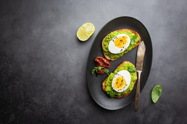 Healthy breakfast toast with avocado and egg top view copy space Vegetarian food concept