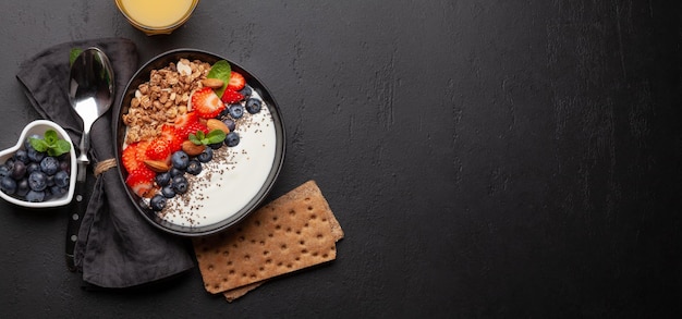 Healthy breakfast with bowl of granola yogurt and fresh berries