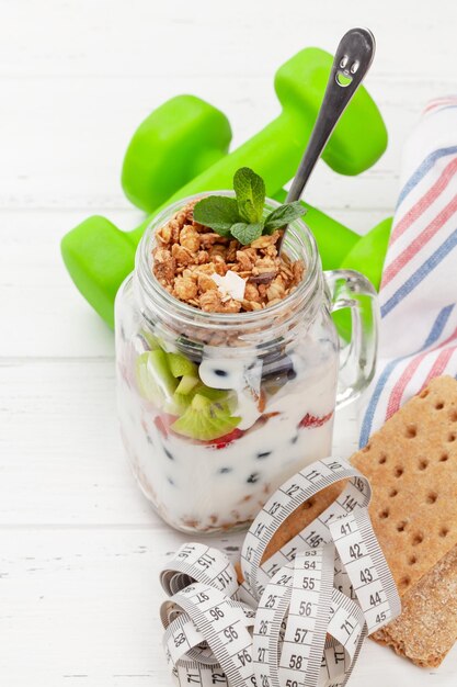 Healthy breakfast with jar of granola yogurt and fresh berries