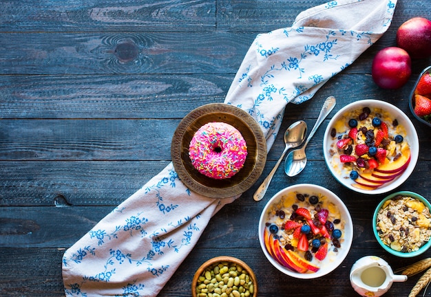 Healthy breakfast with milk,muesli and fruit, on a wooden background.