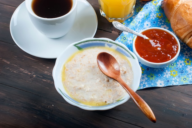 Healthy breakfast with oatmeal with butter,croissant, and coffee