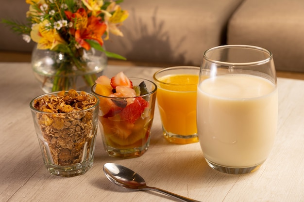 Healthy breakfast with yogurt, granola, fruits and orange juice.