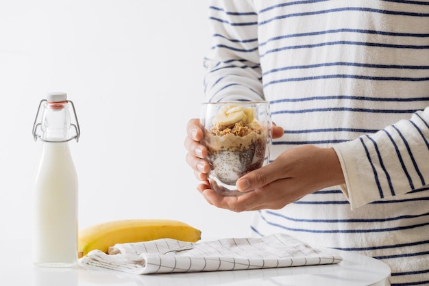 Healthy breakfast with yogurt, nut, banana and chia seeds. Bowl of fresh fruit.