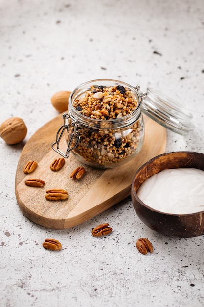 Healthy breakfast yogurt in wooden bowl with granola