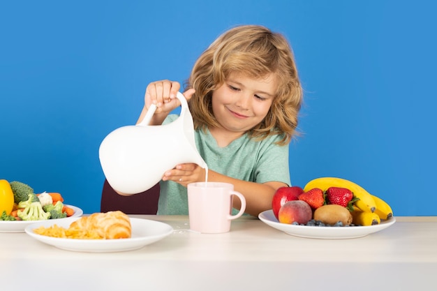 Healthy child pours milk from jug child drink dairy milk