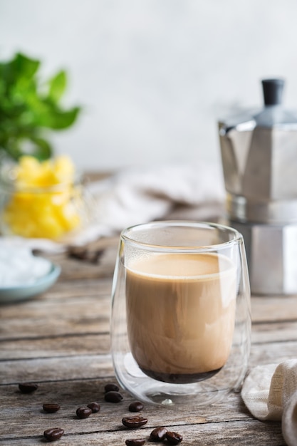 Healthy clean eating concept, keto, ketogenic diet, breakfast morning table. Brewed bulletproof coffee with organic coconut oil, ghee butter, coffee beans. Cozy cafe atmosphere