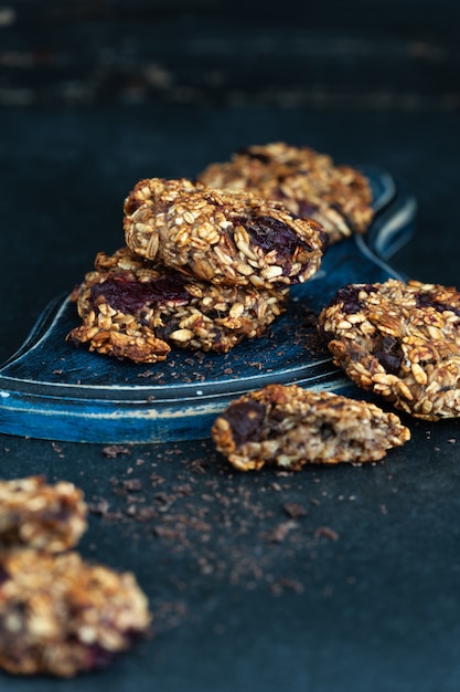 Healthy dessert, fitness food, oatmeal cookies with banana on a dark table