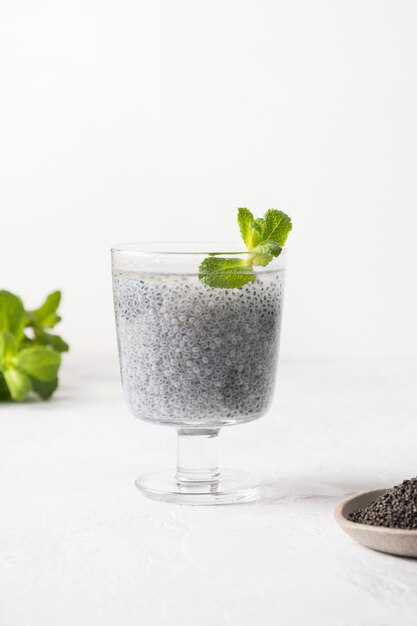 Photo healthy detox beverage with basil seeds in glass