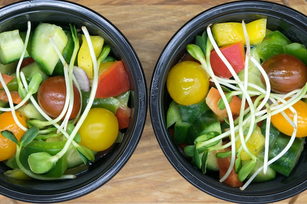 Healthy diet A closeup view of a fresh salad with tomatoes peppers green cucumbers