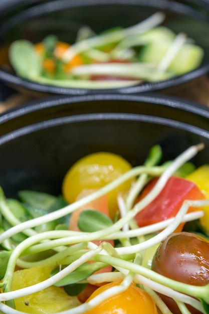 Healthy diet A closeup view of a fresh salad with tomatoes peppers green cucumbers