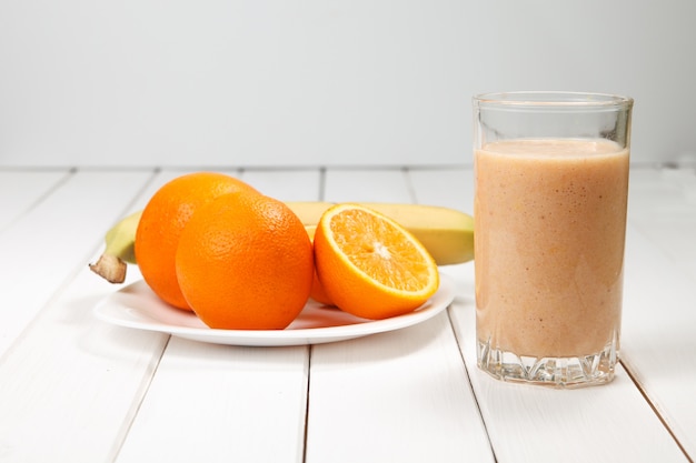 Healthy drink orange and banana smoothies on wooden table