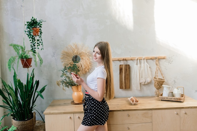 Healthy eating concept. Beautiful young woman with eggs at kitchen.