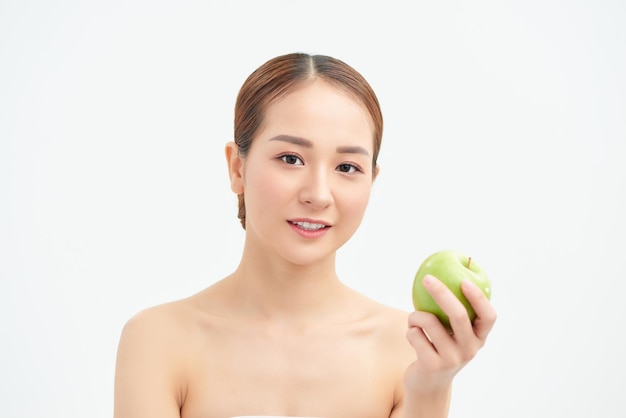 Healthy eating diet and people concept smiling young woman with green apple at home