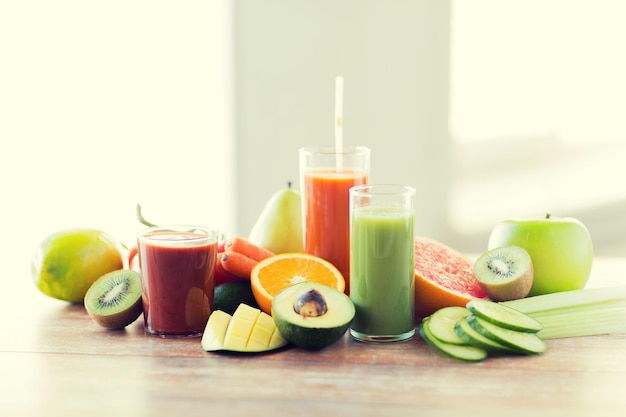 healthy eating, food and diet concept- close up of fresh juice glass and fruits on table