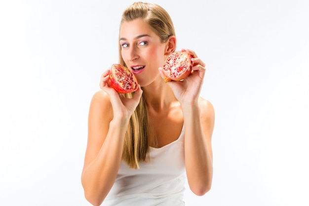 Healthy eating, woman with pomegranate