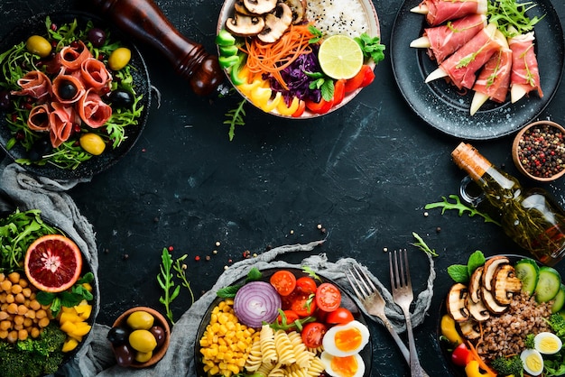 Healthy food Assortment of the Buddha Bowl on a black background Top view Free space for your text