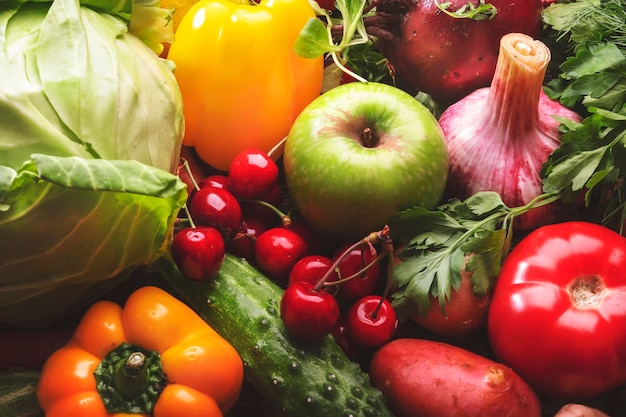 Healthy food Assortment of fresh summer organic vegetables fruits and berries on wooden table background