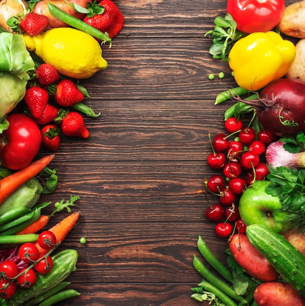 Healthy food Assortment of fresh summer organic vegetables fruits and berries on wooden table background