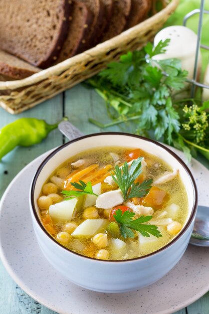 healthy food chicken and chickpea soup on wooden table diet menu