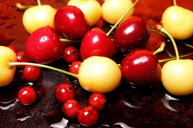 Healthy food concept Closeup of sweet berries with drops of water on a black background View from above