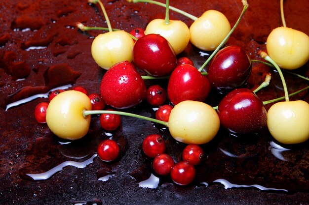 Healthy food concept Closeup of sweet berries with drops of water on a black background View from above