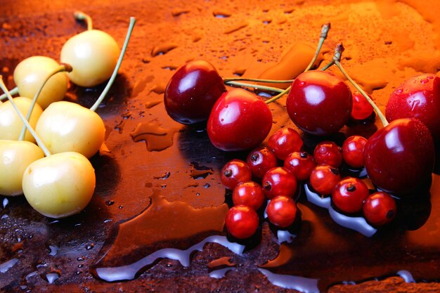 Healthy food concept Closeup of sweet berries with drops of water on a black background View from above