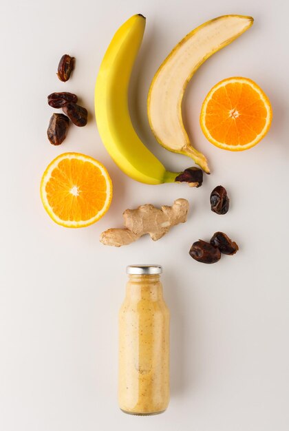 Healthy food. Detox smoothie with ingredients on white background, top view, copy space.