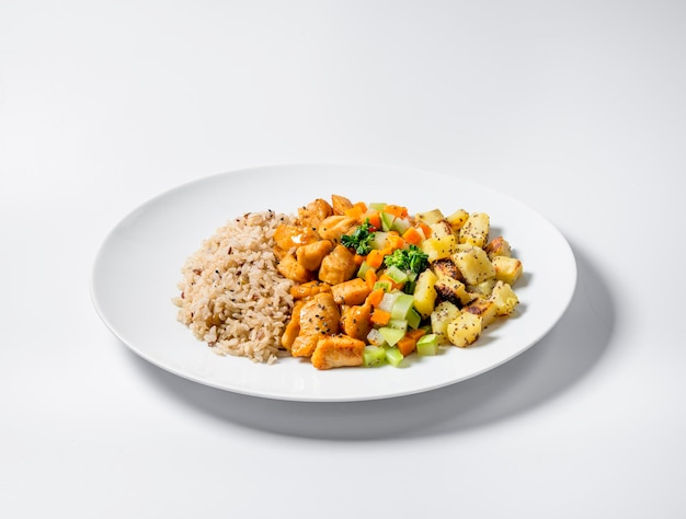 Healthy food diced chicken vegetable salad sweet potato and brown rice isolated on white background