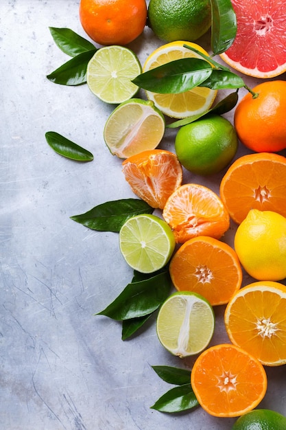 Healthy food diet nutrition nature concept Citrus fruits vitamin background Orange grapefruit tangerine lime lemon with leaves on a grunge table Copy space top view flat lay overhead