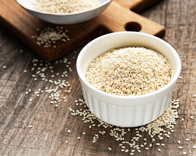 Healthy food and drink concept. Sesame seeds in a bowl  on a rustic table