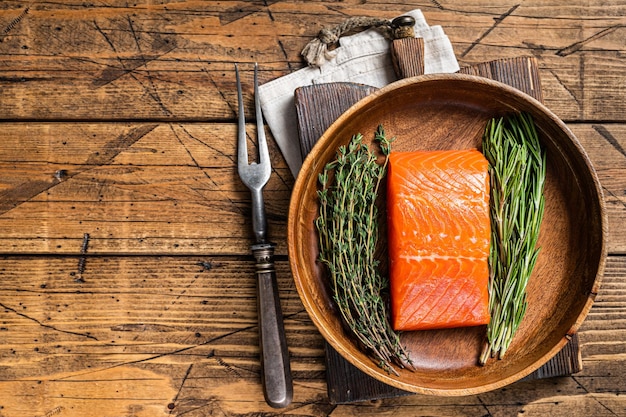 Healthy food fresh salmon fillet steak with herbs Wooden background Top view Copy space