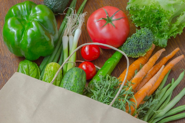 Healthy food in full paper bag of different products, vegetables. Top view.