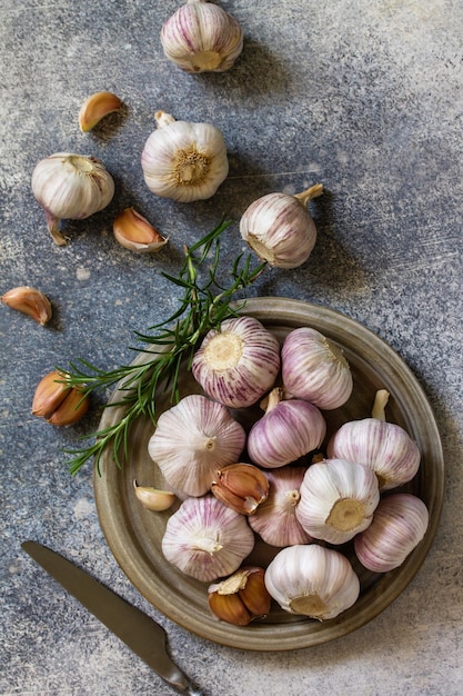 Healthy food Garlic Cloves and Bulb on a stone or slate table Top view flat lay background