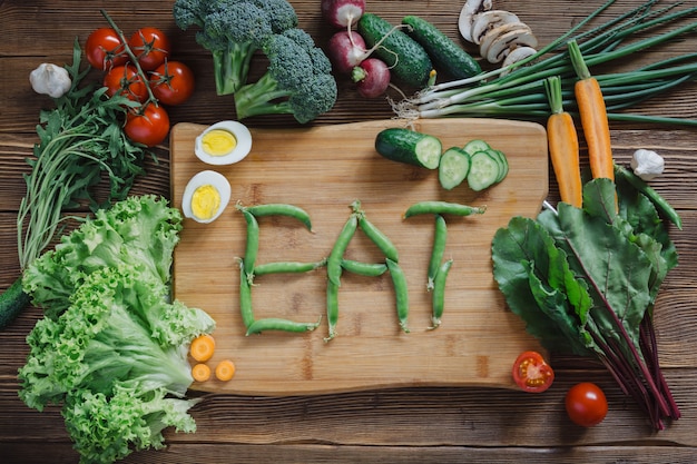 Healthy food and ingredients on rustic wooden board