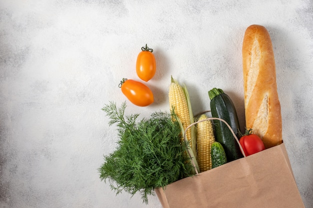 Healthy food selection. Shopping bag paper full of fresh vegetables. Flat lay food on table.