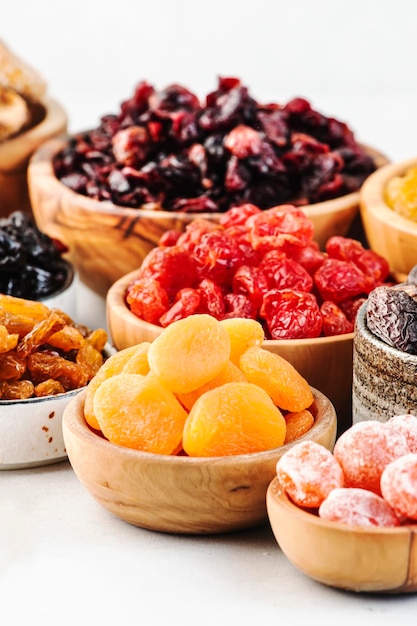 Healthy food snacks natural dried fruits mix in bowls on white background