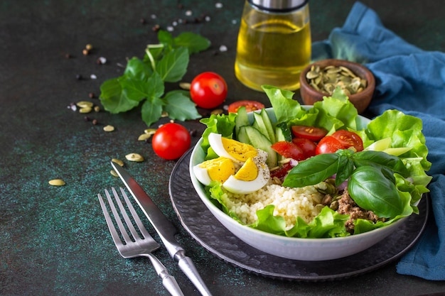 Healthy food Tuna salad with egg lettuce quinoa vegetables and pumpkin seeds Copy space