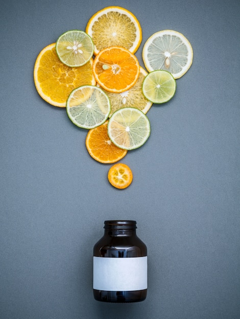 Healthy foods and medicine concept.  Mixed citrus fruits sliced on gray background flat lay.